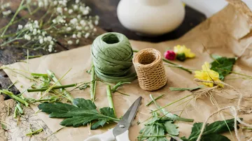 Craft supplies on paper with flowers.