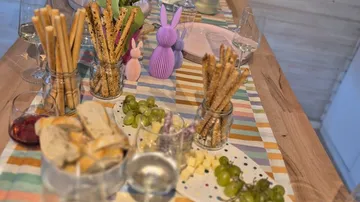 Table with snacks, drinks, and decorative bunnies.