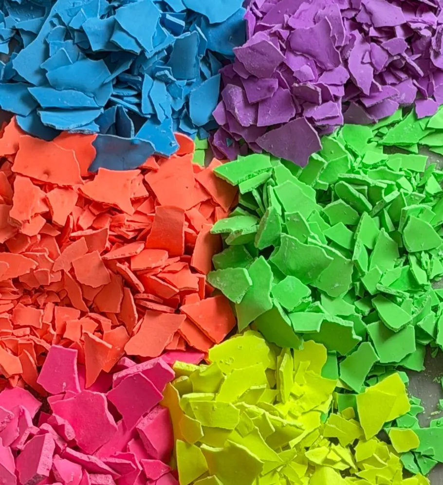 Colored plastic flakes arranged by color.