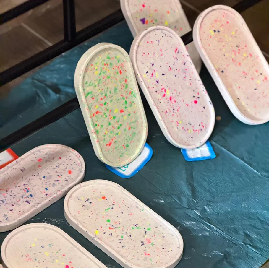 Colorful speckled trays on a blue surface.