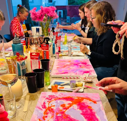 Group painting session with colorful canvases.