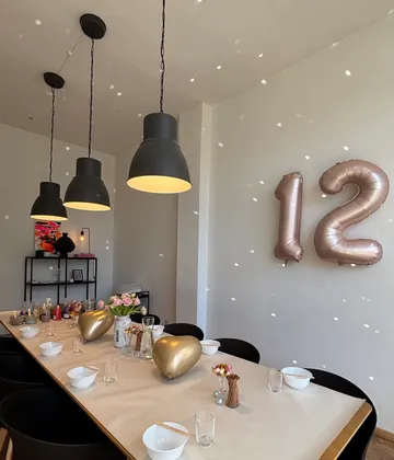 Dining table set with decoration, number balloons.