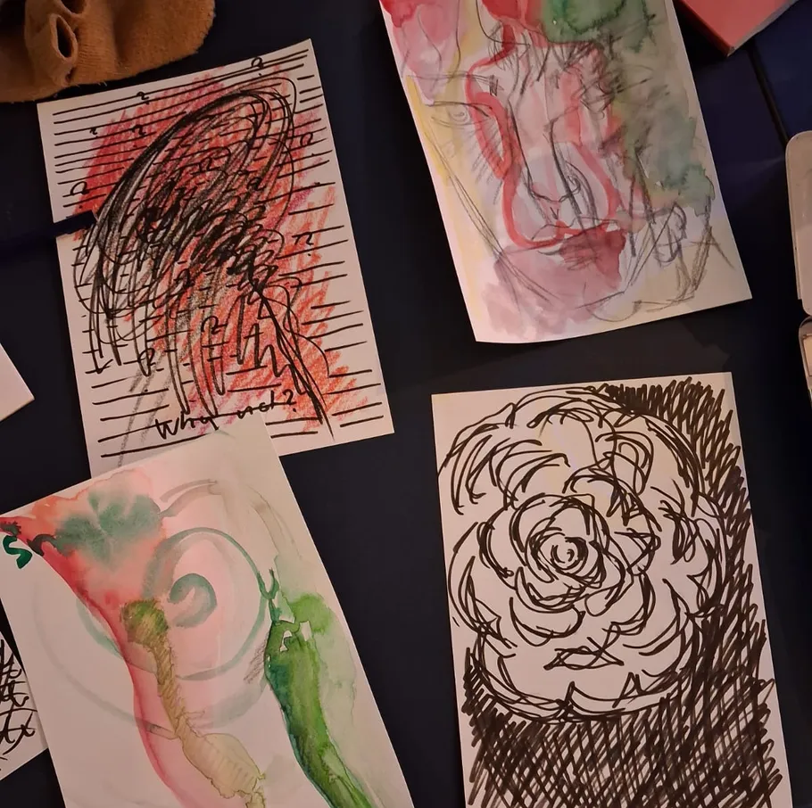 Abstract sketches and watercolor paintings on table.