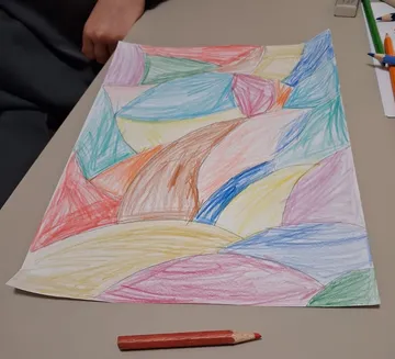 Colorful abstract drawing on a table.
