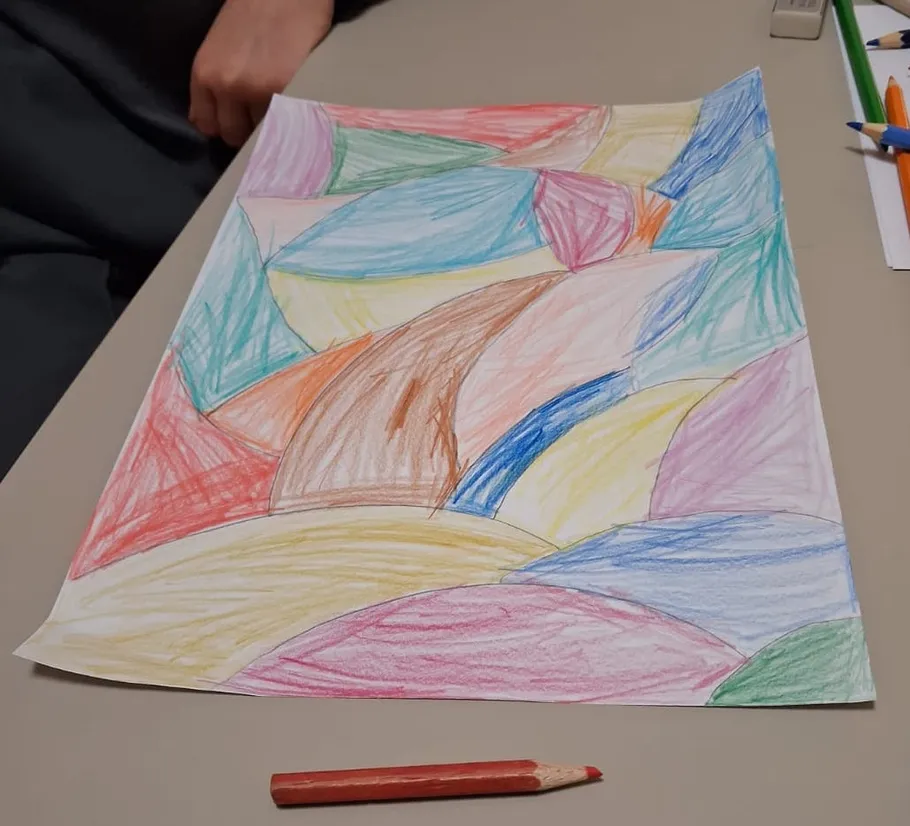 Colorful abstract drawing on a table.
