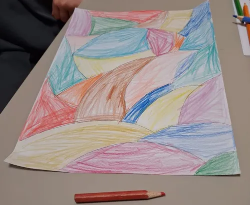 Colorful abstract drawing on table with pencil.