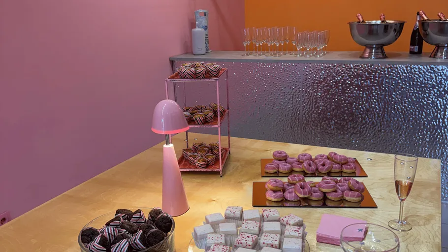 Pink-themed buffet with desserts and drinks.