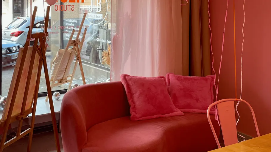 Red couch with pillows in cozy studio.