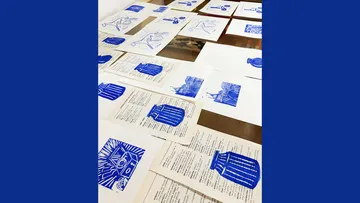 Blue prints on paper sheets on a table.