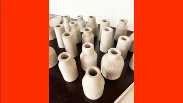 Gray ceramic vases arranged on a table.