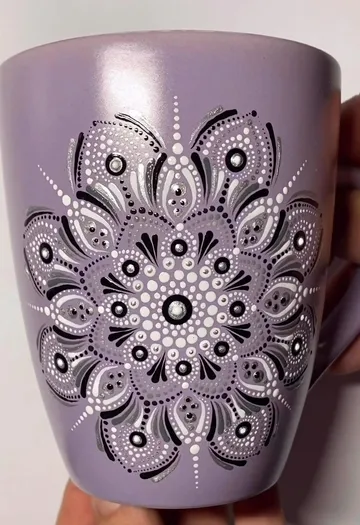 Purple mug with intricate dot mandala design.