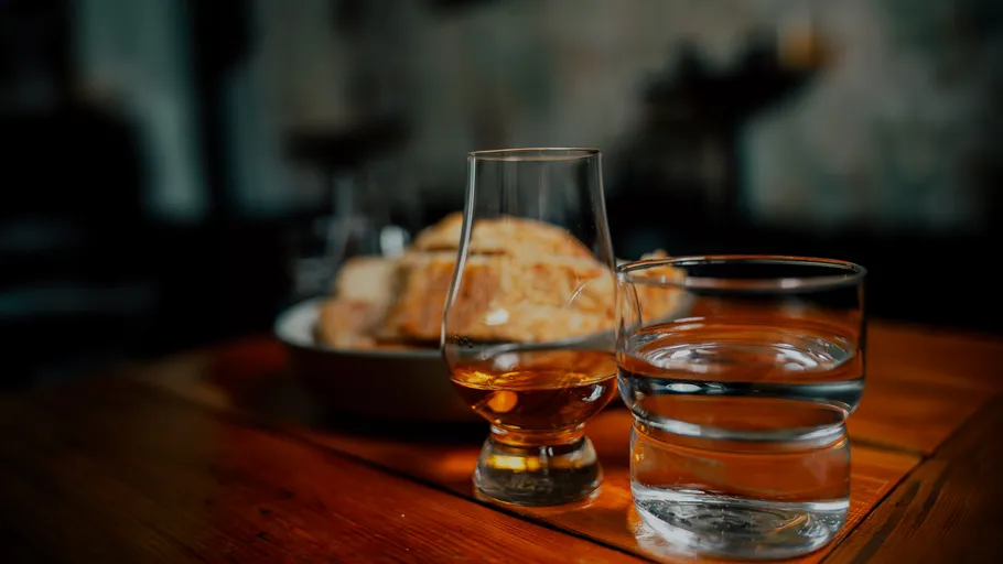 Whiskey and water on wooden table.