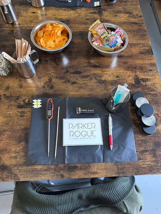 Wooden table with snacks and writing tools.