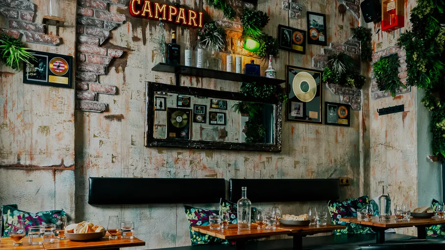 Decorative restaurant wall with shelves and pictures.
