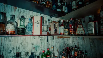 Shelf filled with various liquor bottles.