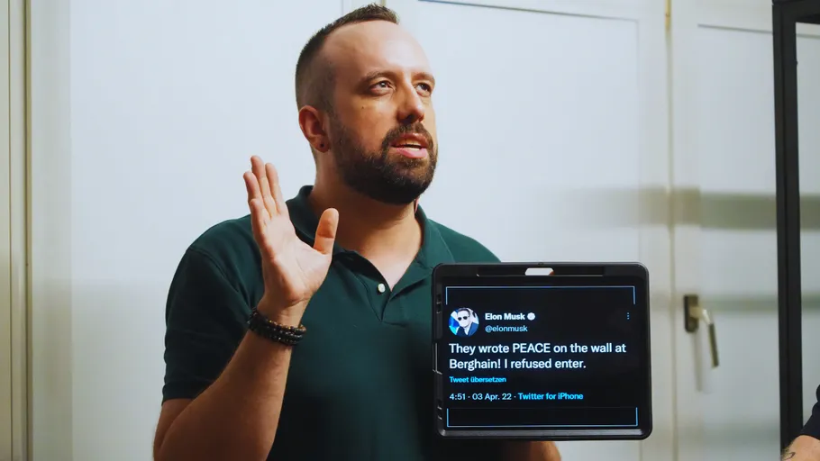 Mann hält ein Tablet mit einem Tweet.