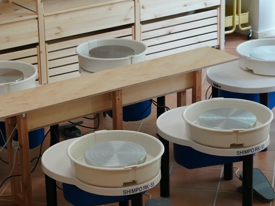 Pottery wheels in a workshop setting.