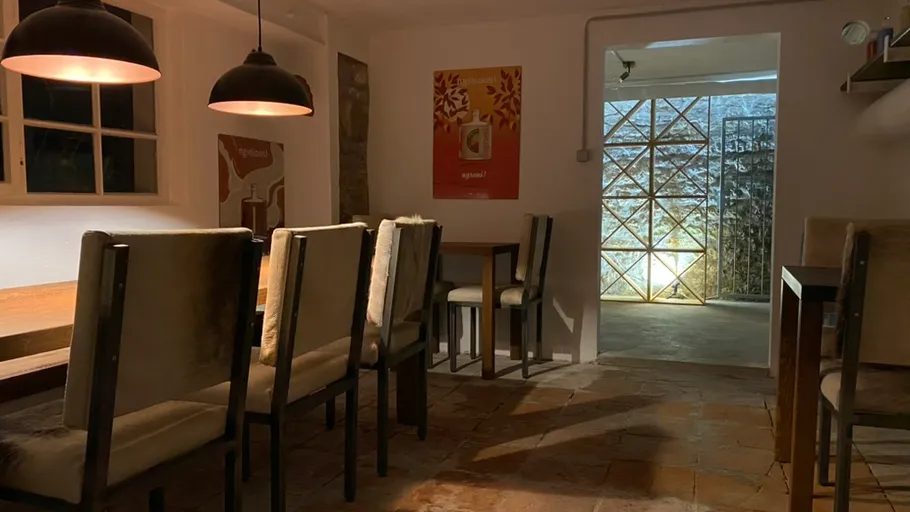 Rustic dining room with wooden tables, chairs.