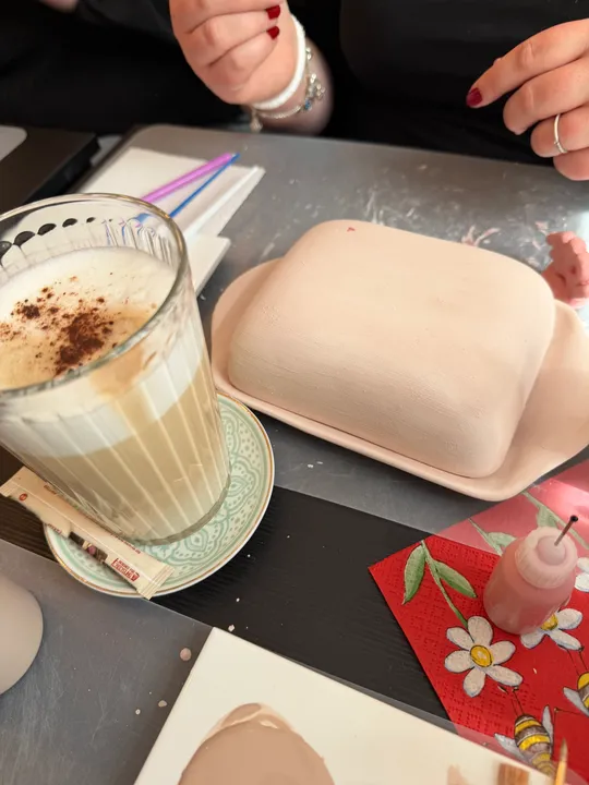 Hands preparing crafts with coffee on table.