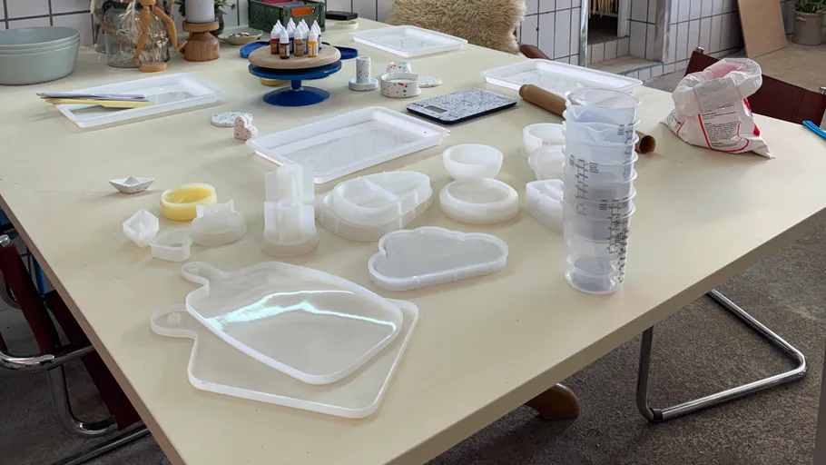 Craft materials and molds on a table.