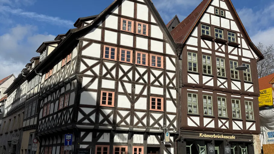 Historic half-timbered buildings under blue sky.