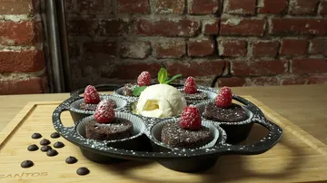 Chocolate soufflés with raspberries and ice cream.