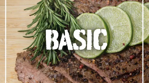 Grilled steak with lime, rosemary on board.