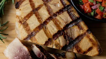 Grilled swordfish steak with vegetables.