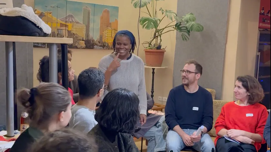 Group chatting and laughing in a cozy room.
