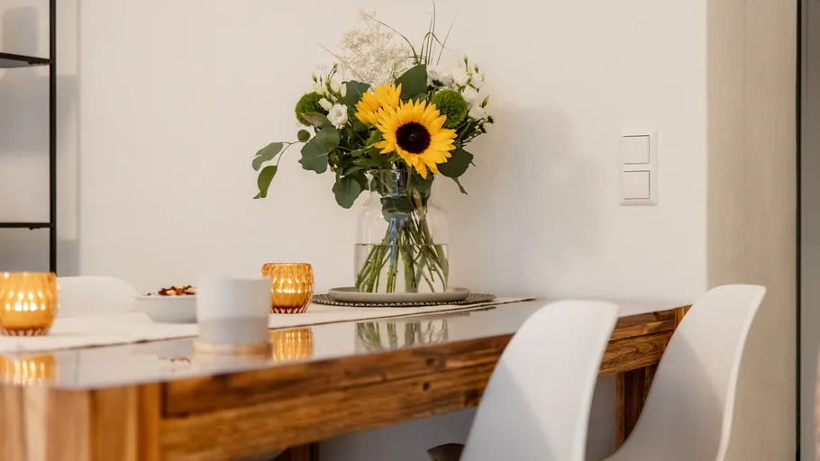 Sunflowers in a vase on dining table.