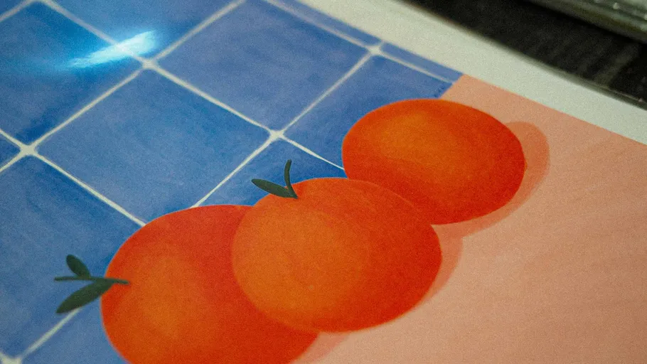 Three oranges on a checkered blue background.