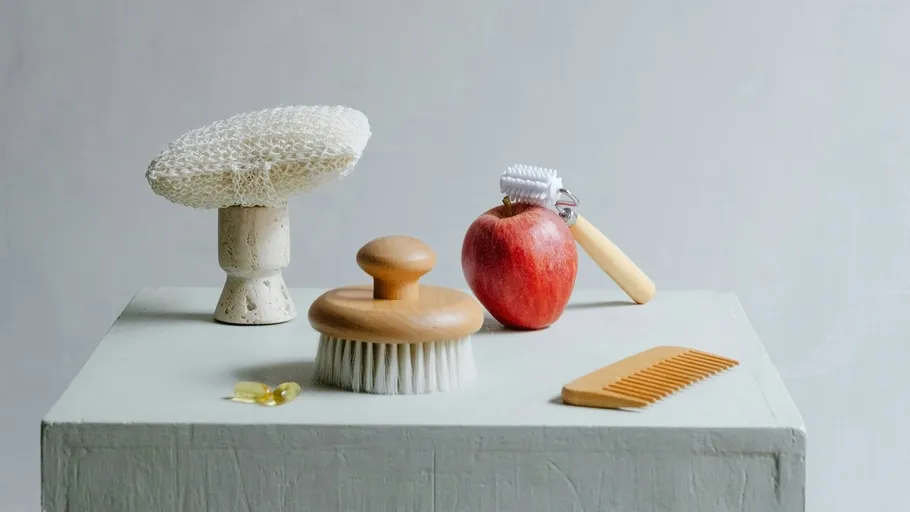 Grooming items and apple on a table.