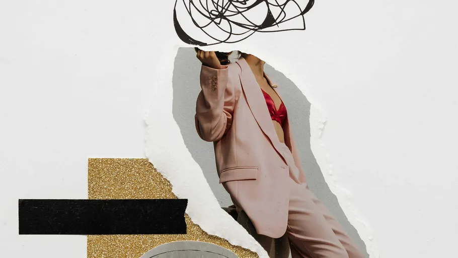 Woman in pink suit with abstract cutout art.