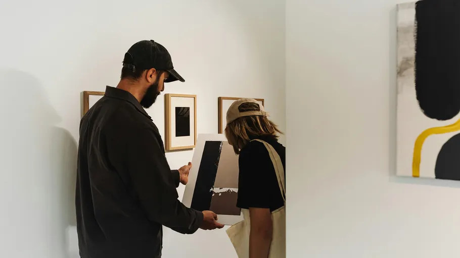 Two people viewing art in a gallery.