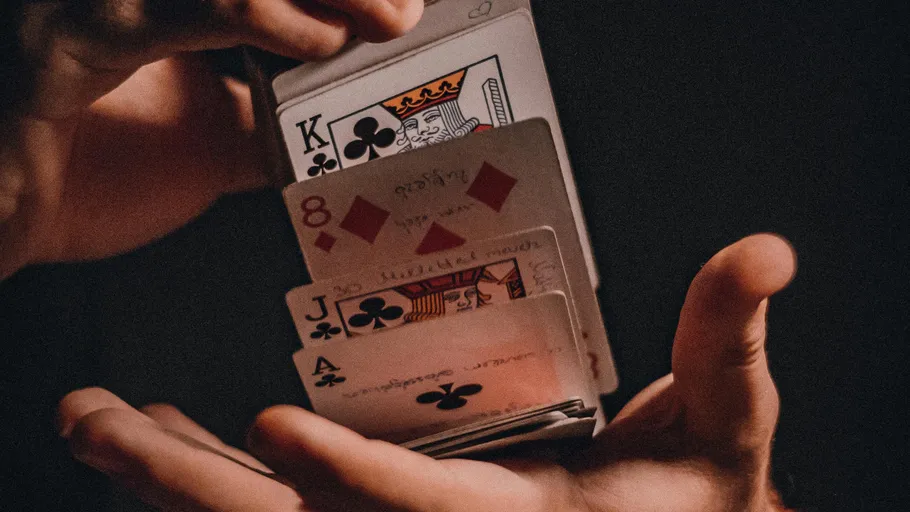 Hands shuffling playing cards in motion.