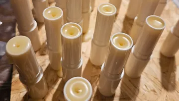 White tubes filled with cream on wooden surface.