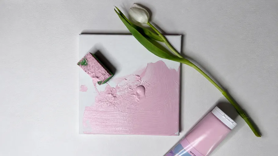 Canvas painted pink with tulip and paint tube.