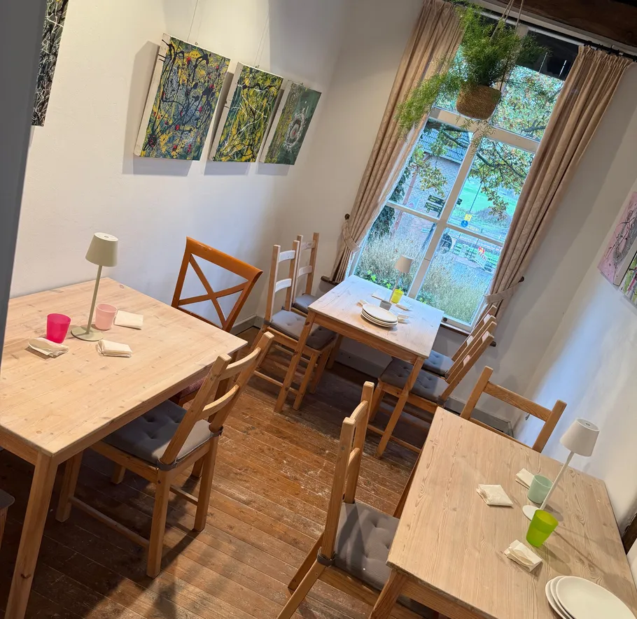 Wooden tables and chairs in a cozy cafe.