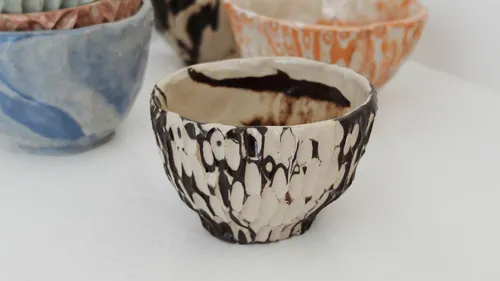 Decorative bowls with unique patterns on display.