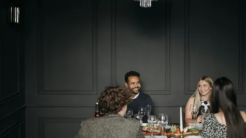 People dining together in a dark room.