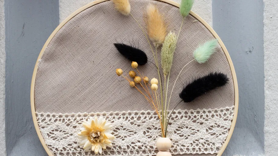 Decorative embroidery hoop with dried flowers.