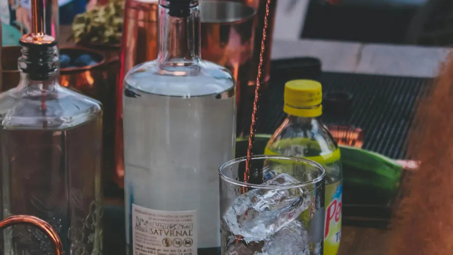 Glass with ice being filled with a drink.