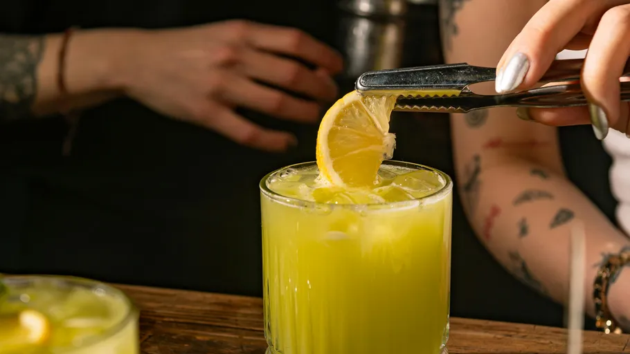 Lemon slice placed on bright cocktail glass.