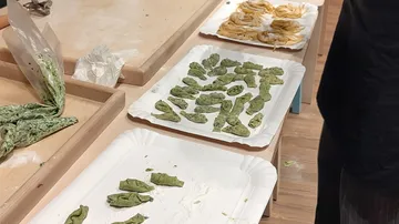 Handmade pasta varieties displayed on tables.