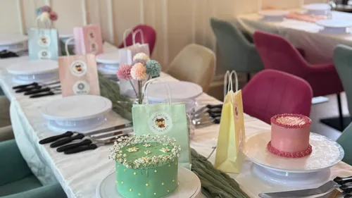 Table set with cakes and gift bags.