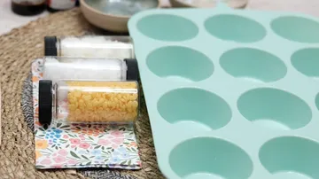 Muffin tray with jars of ingredients nearby.