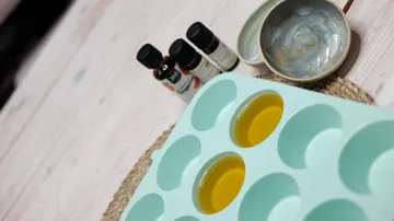 Silicone mold with liquid near essential oils.