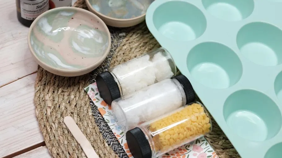 Craft supplies and molds on a woven mat.