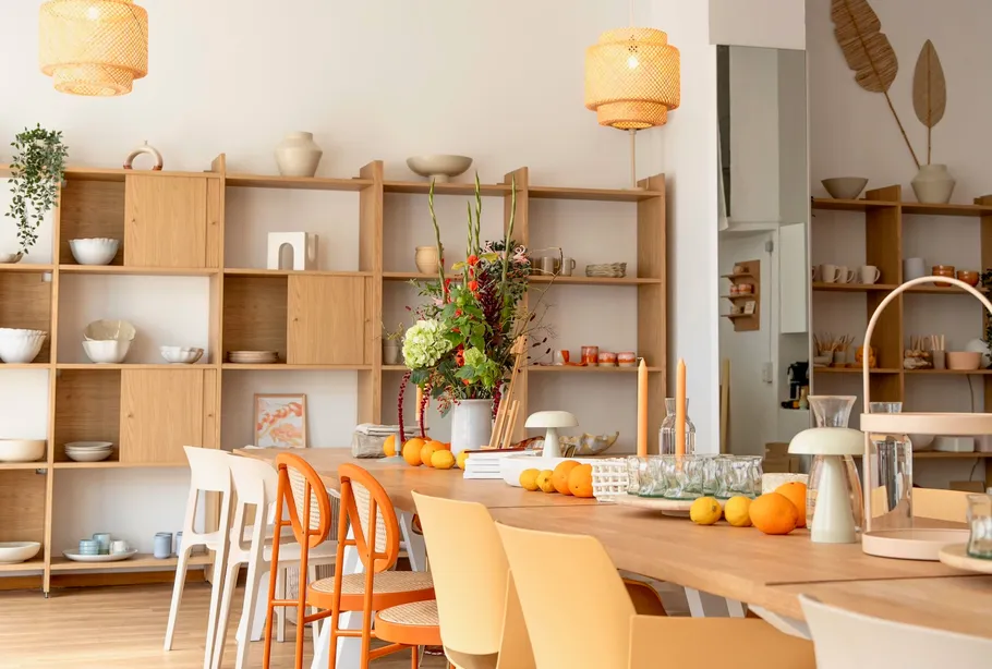 Dining area with wooden shelves and table.