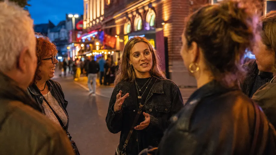 Group of people chatting on a busy street.